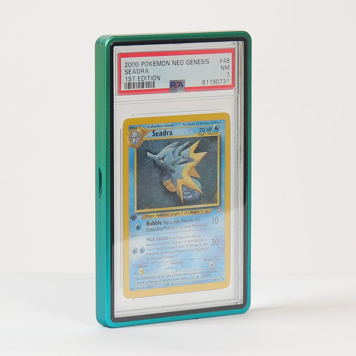 A graded Pokémon TCG card in a clear PSA-style slab with a teal-green protective case, standing upright on a white surface against a white background.