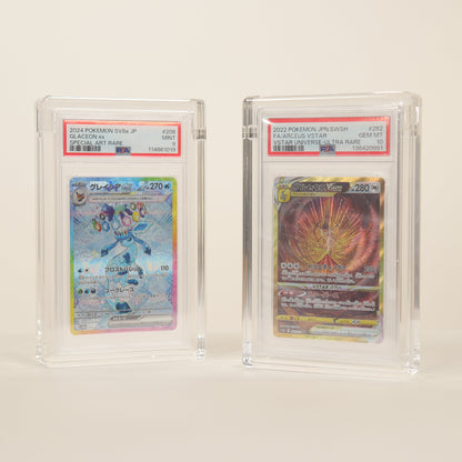 Two trading cards in protective cases on a white background